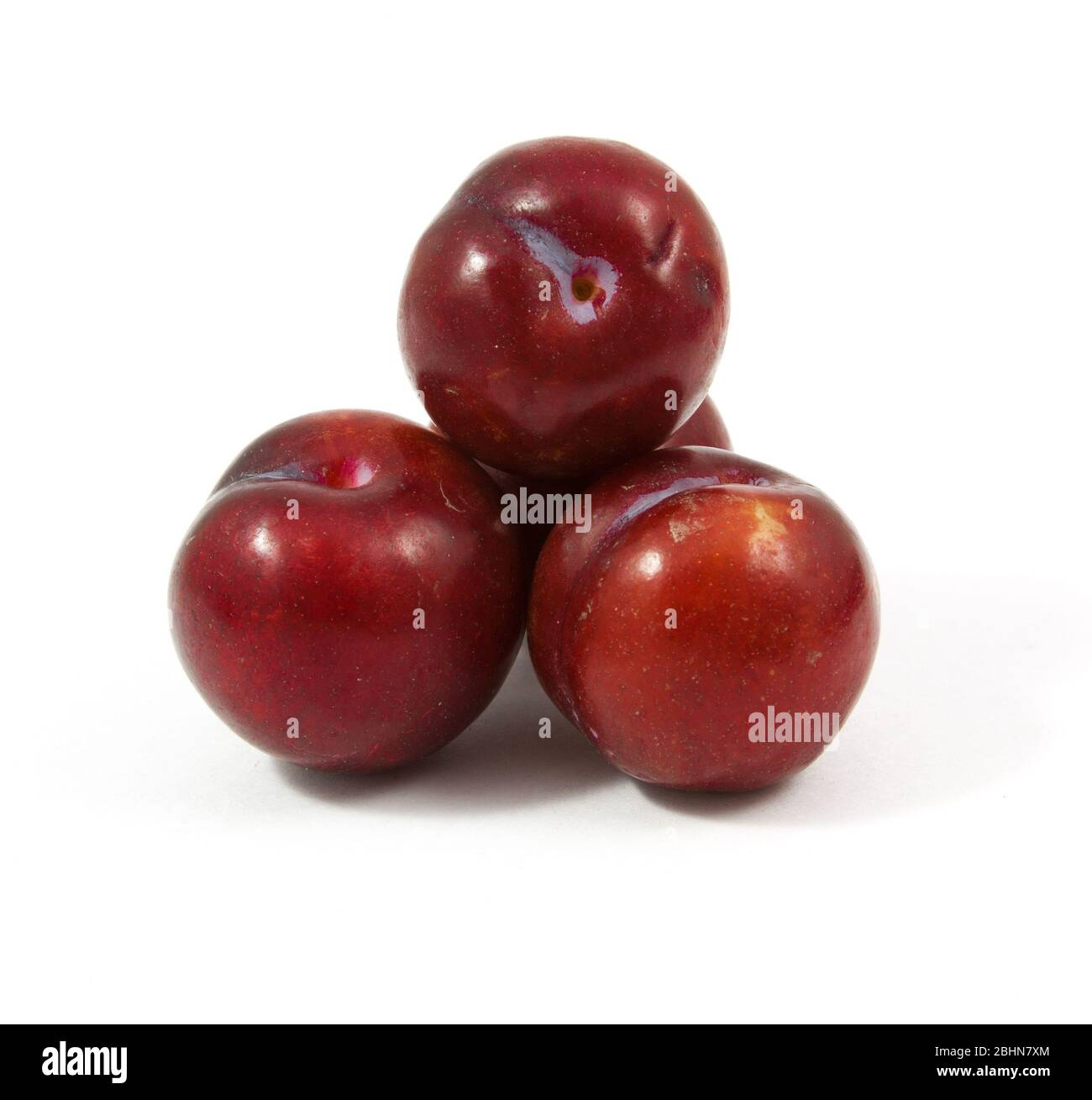 ripe purple cherry plums isolated on white Stock Photo