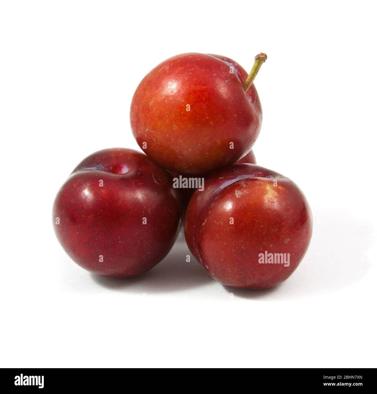 ripe purple cherry plums isolated on white Stock Photo