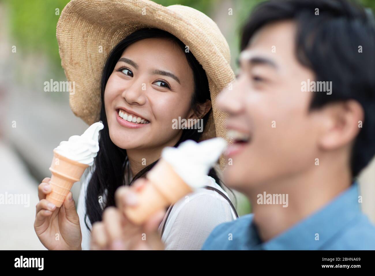Happy young Chinese couple eating ice cream Stock Photo Alamy