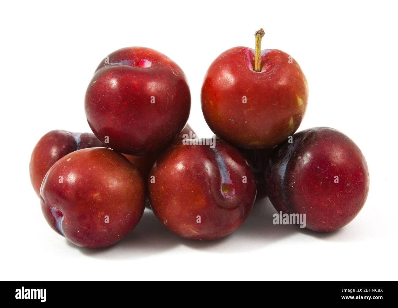 ripe purple cherry plums isolated on white Stock Photo