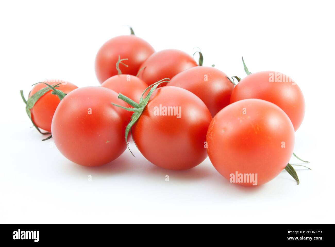 organic red tomatoes on white background Stock Photo - Alamy