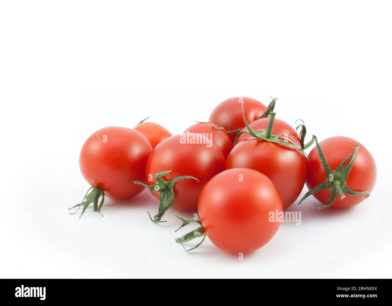 organic red tomatoes on white background Stock Photo - Alamy