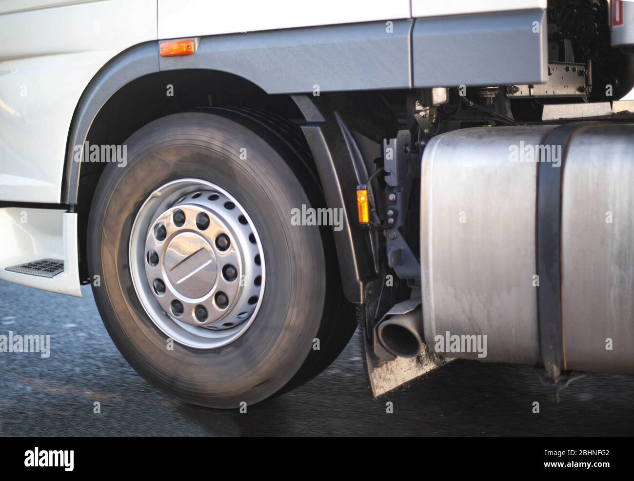 Spinning wheel of a truck and a fuel tank with an exhaust pipe. Road safety concept and adblue system, Euro 6, ecology Stock Photo