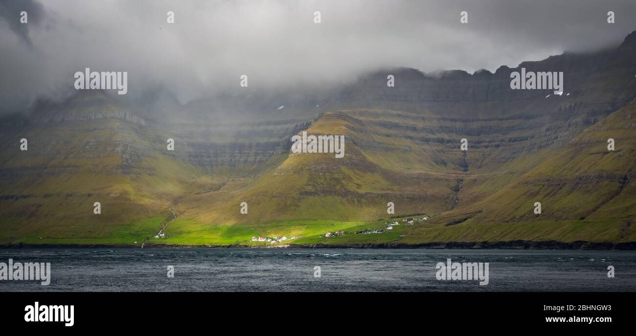 Small village of Kunoy in Faroe Islands fjord Stock Photo