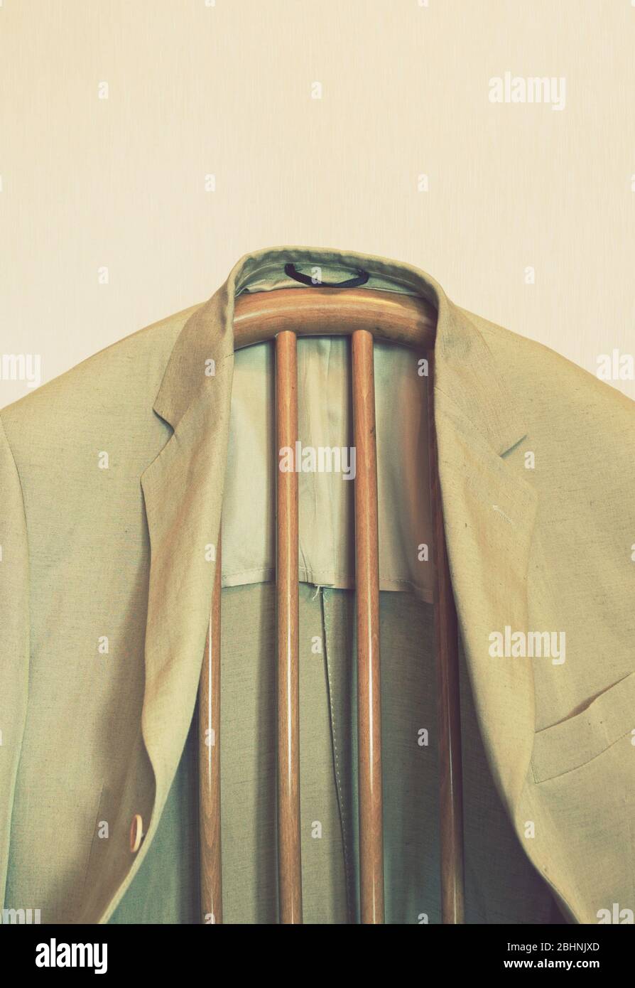 a vintage style male jacket hanging on chair Stock Photo - Alamy