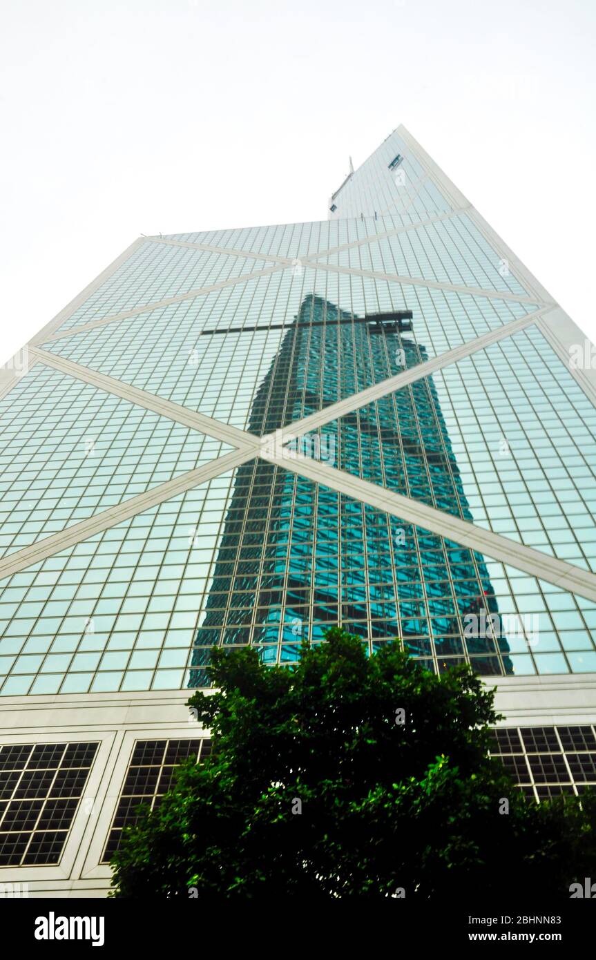 HONG KONG, June,10 2013: Cheung Kong Centre reflected over the facade of the Citibank Tower, a modern glass and steel office skyscraper Stock Photo