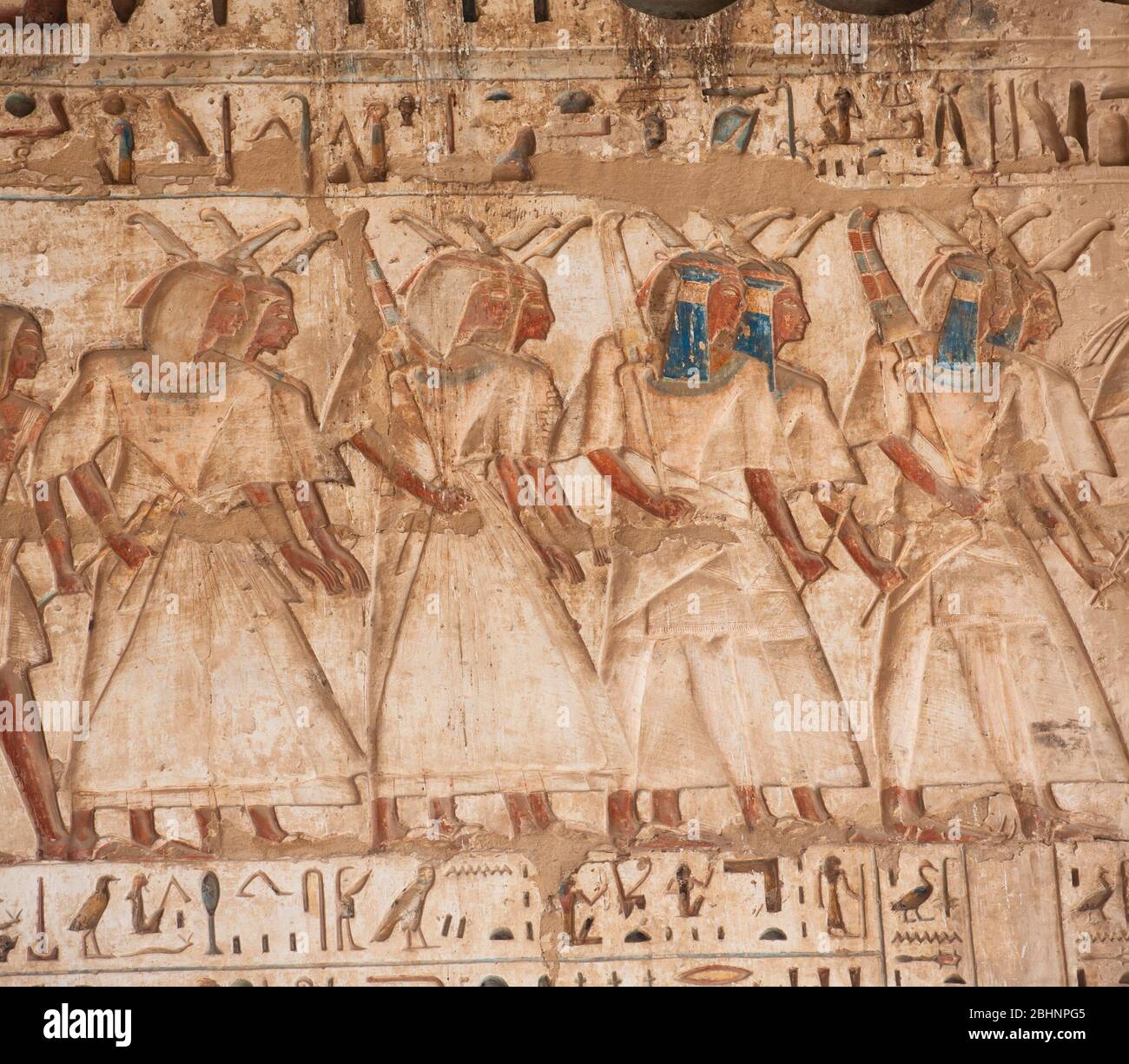 Hieroglypic carving painting on wall at the ancient egyptian temple of Medinat Habu in Luxor Stock Photo