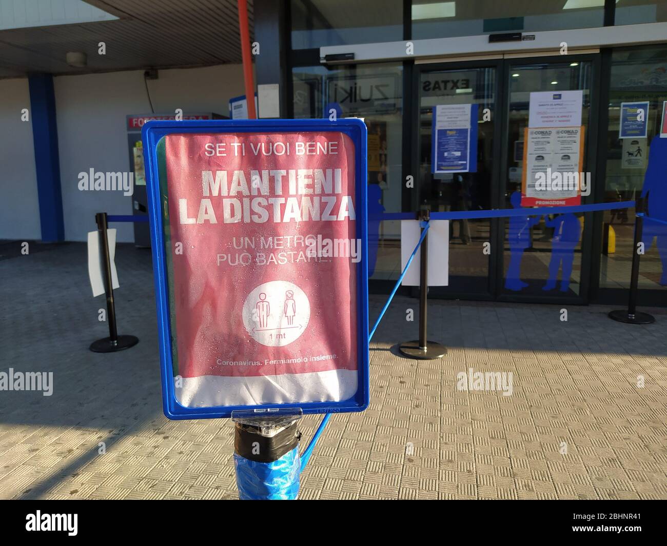 A sign with prescriptions to prevent the spread of infection from covid-19 placed at the entrance of a shopping center to warn customers. Stock Photo