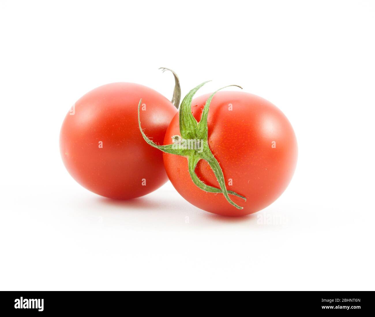organic red tomatoes on white background Stock Photo - Alamy