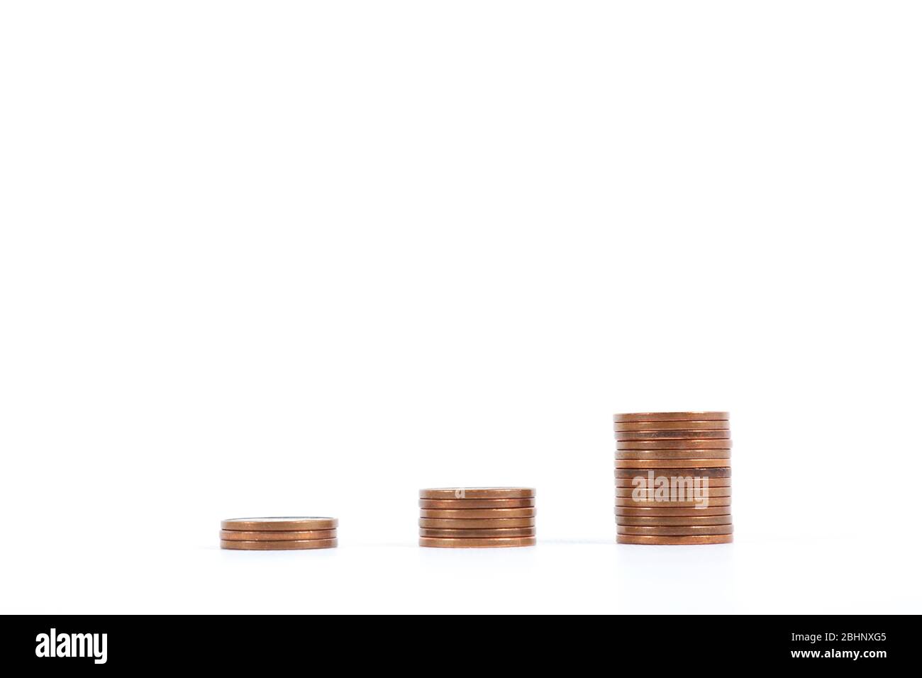 three piles of progressively growing coins. Concept of savings, economy and finance Stock Photo