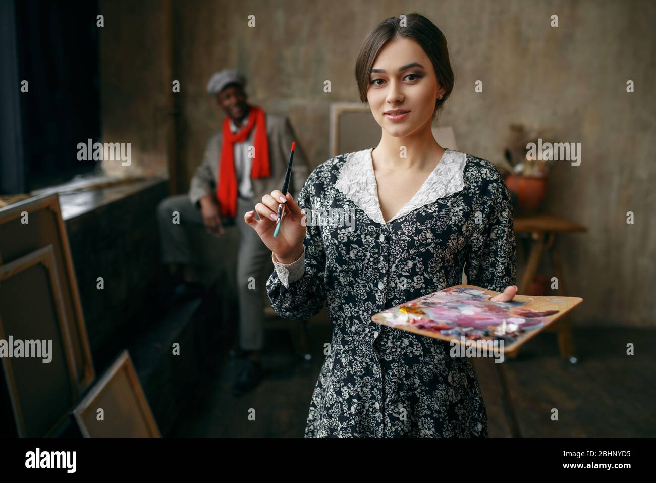 Female portrait painter holds palette and brush Stock Photo - Alamy