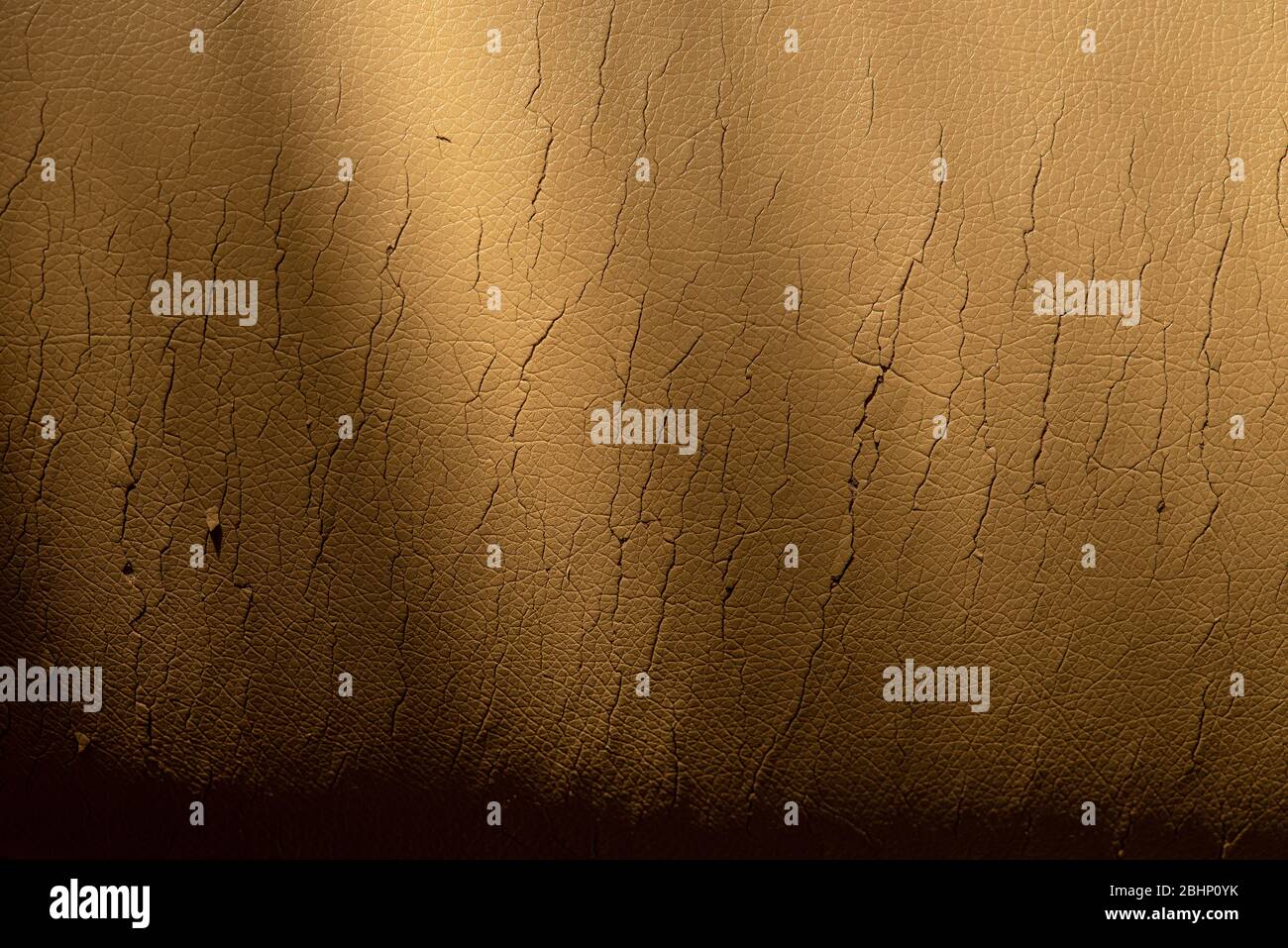 Cracked beige leather texture. Background in bad condition. Stock Photo