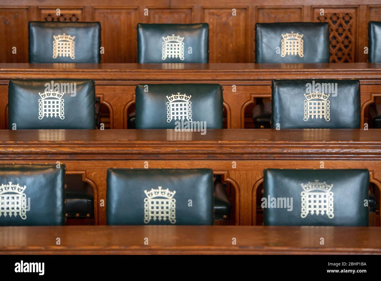 Empty seats in the Palace of Westminster. House of Commons meeting room. Stock Photo