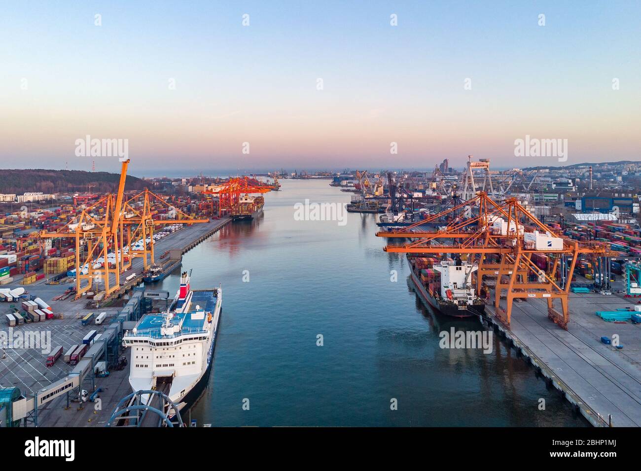 03.04.2020 Gdynia Logistics and transportation of containers. Cargo ship with crane bridge. Import, export industry aerial view from drone, from above Stock Photo