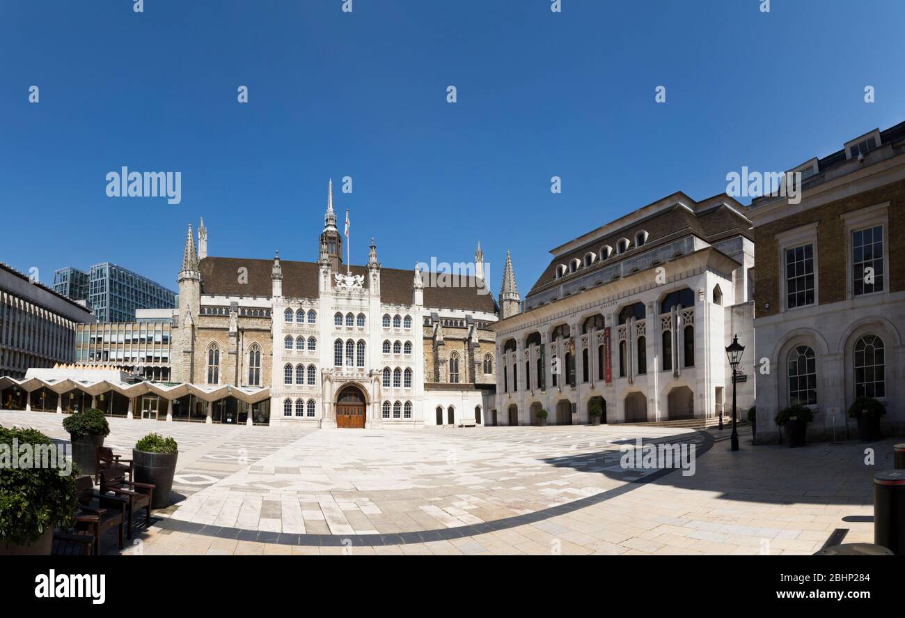 Panorama / panoramic view of the Guildhall Great Hall, centre; Aldermens Court / West wing (L); Art Gallery (R). City of London UK. On the ground an 80 m wide curved line of dark stone follows the edge of the original Roman amphitheatre. (118) Stock Photo