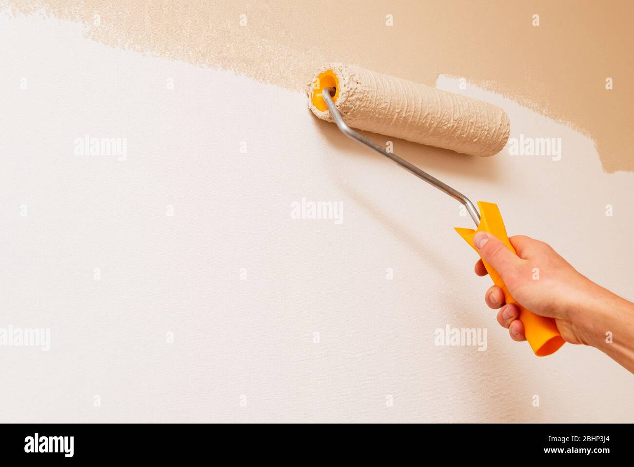 Painting the walls of a room. Paint Roller Techniques Stock Photo