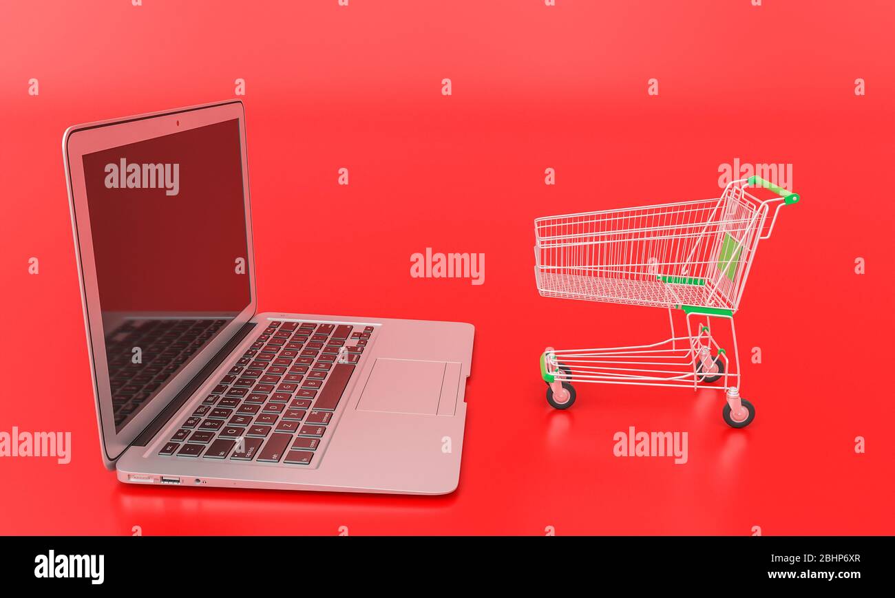 shopping cart in front of a laptop on red background. online shopping, e-commerce concept. 3d render. nobody around. Stock Photo