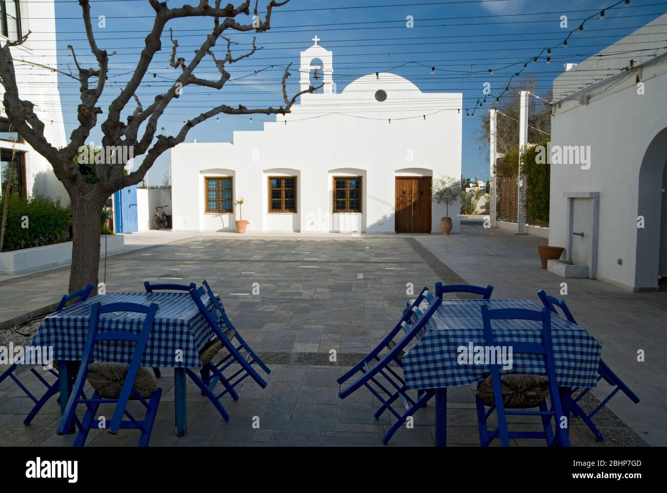 Greek Chapel and taverna tables, Aliathon Holiday Village, Paphos, Cyprus. Stock Photo