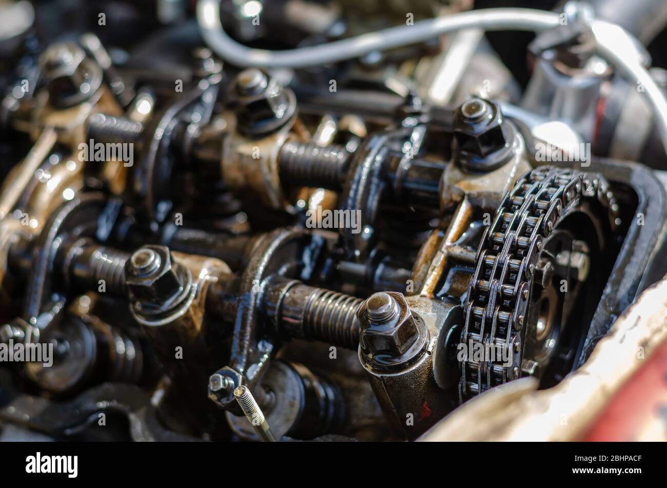 A detailed shot of the cylinder head of a carburetor engine. Four