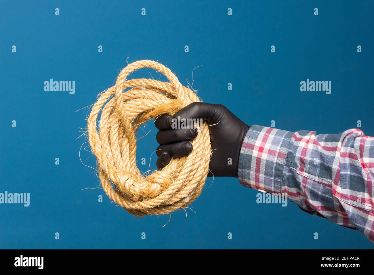 Yellow rope in the expert hand of an adult with protection. Thick