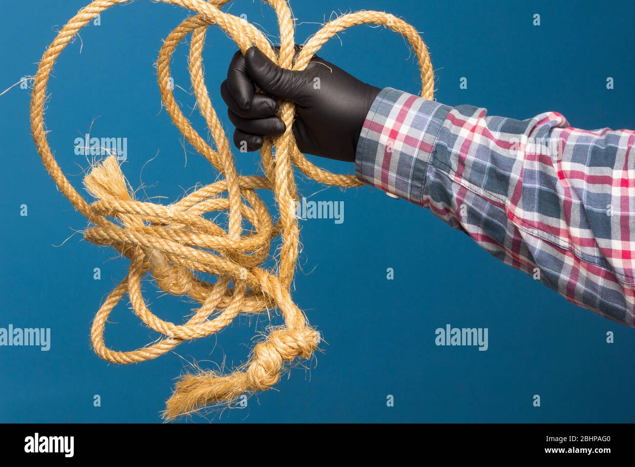 Yellow rope in the expert hand of an adult with protection. Thick