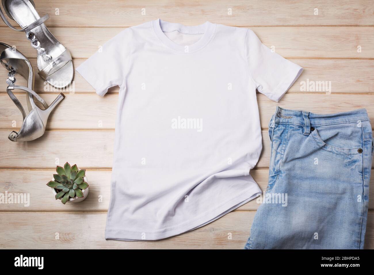 White women’s cotton T-shirt mockup with silver open toe heels sandals and succulent plant. Design t shirt template, tee print presentation mock up Stock Photo
