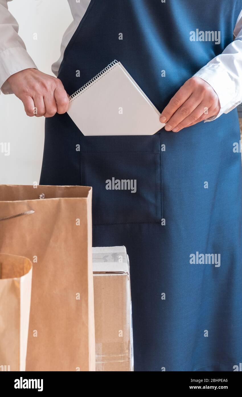 A lot of Craft Paper Bags and Boxes stay near by Packer. Worker of ...
