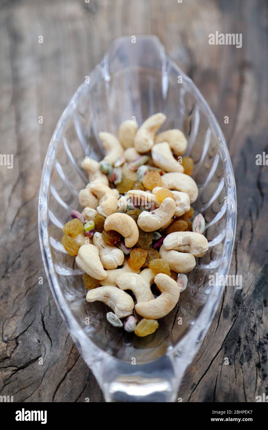 Delicious and healthy mixed dried fruits, nuts and seeds Stock Photo