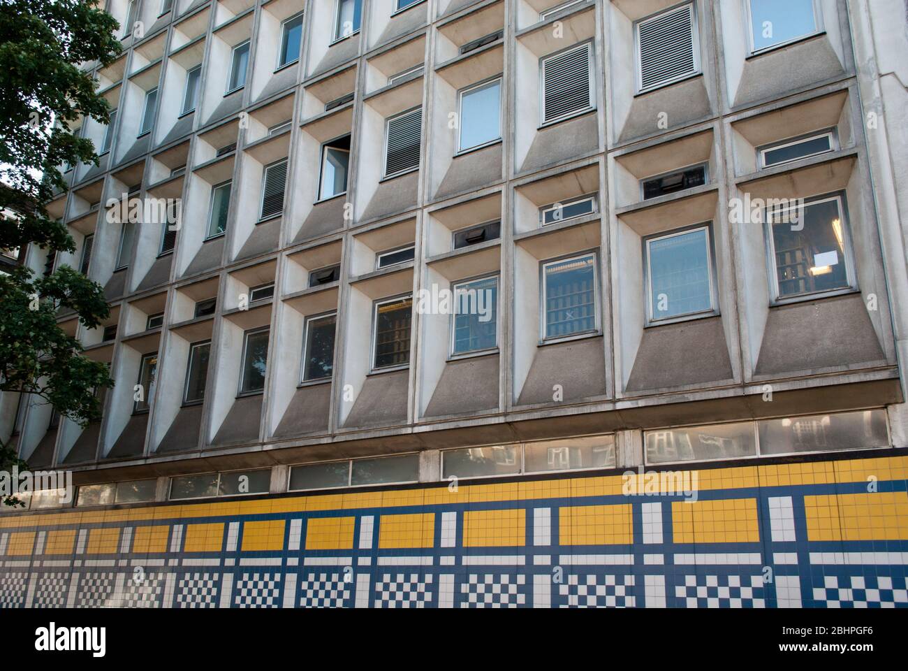 Blue & Yellow Mosaic Tiled Wall Squares Geometric Tiles Concrete Shepherds Bush Telephone Exchange, Uxbridge Road, London, W12 Stock Photo