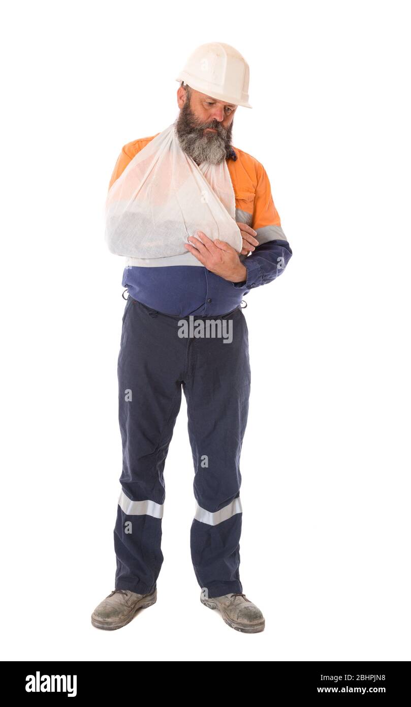 A full length image of an industrial worker injured in an accident with depressed expression, isolated on white. Stock Photo
