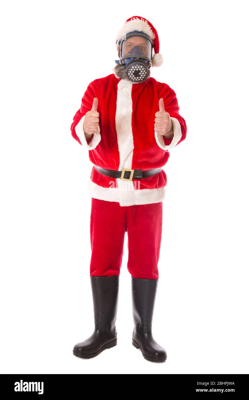 Santa wearing protective gear against coronavirus,thumbs up for a positive holiday. Stock Photo