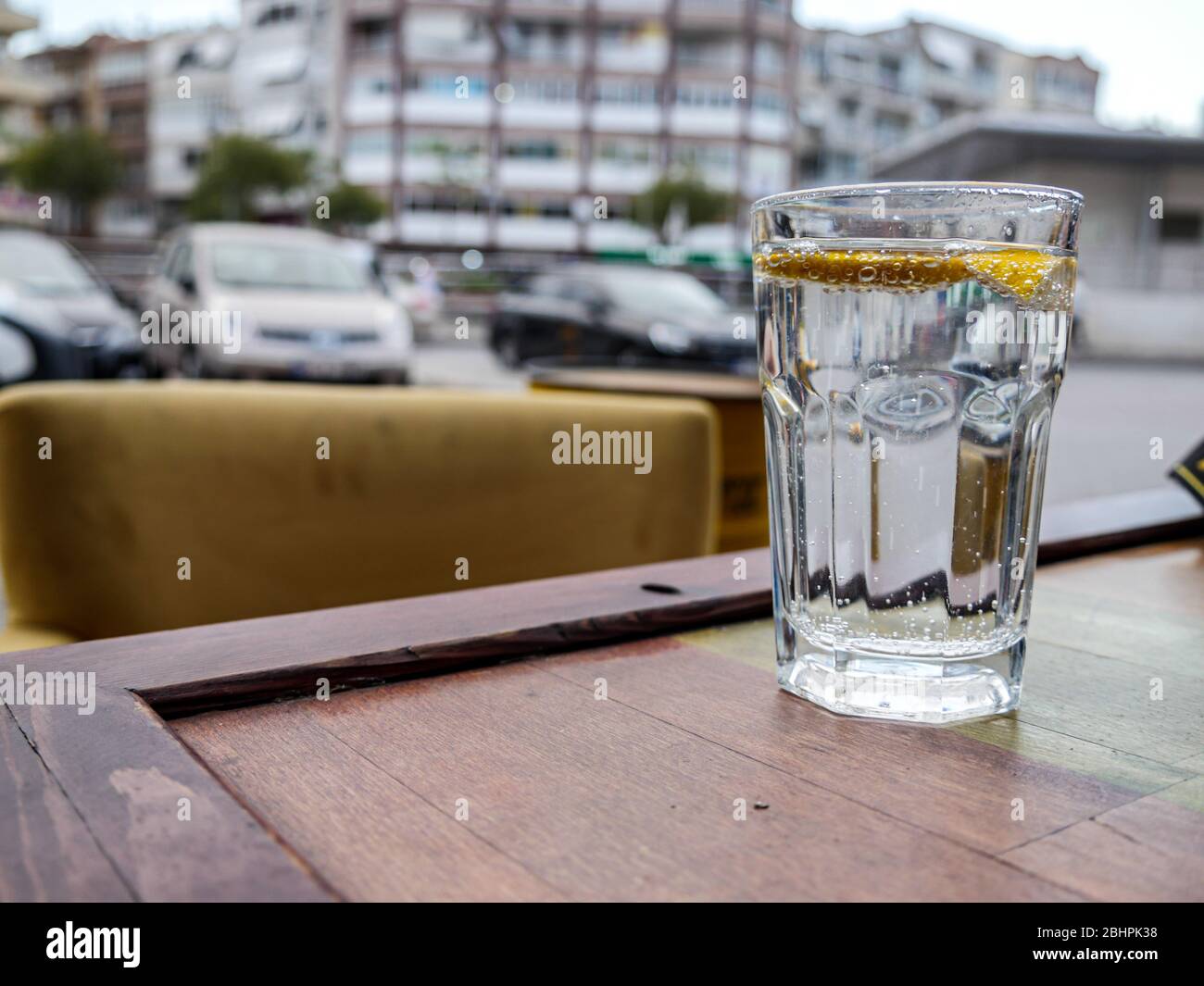 glass of sparkling water with lemon slices on table. drink and refreshment concept Stock Photo