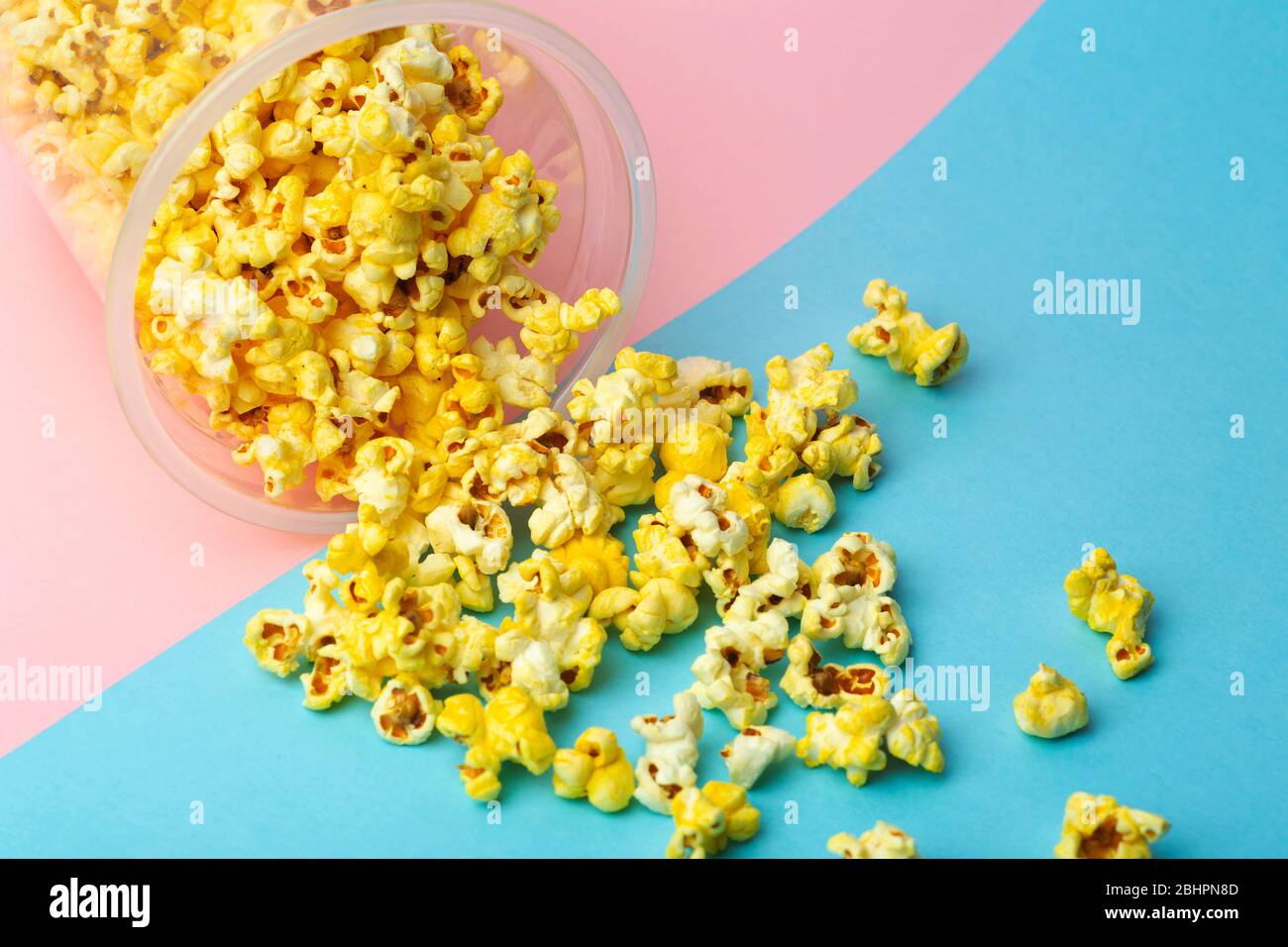 Popcorn on a colored background. Minimal food concept. Entertainment, film and video content. Aesthetics 80s and 90s concept Stock Photo