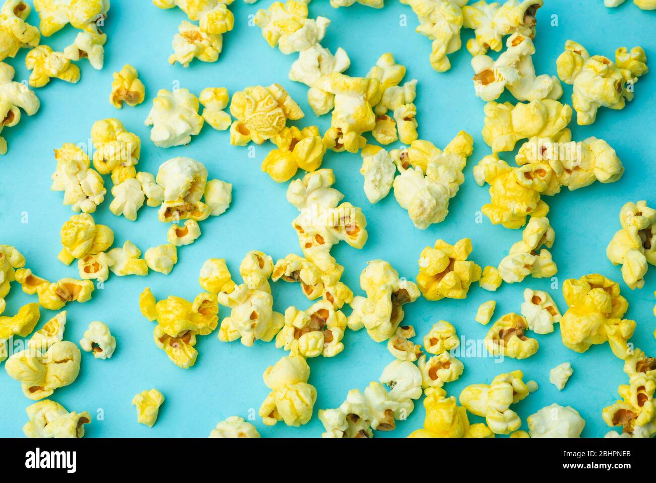 Popcorn on a colored background. Minimal food concept. Entertainment, film and video content. Aesthetics 80s and 90s concept Stock Photo