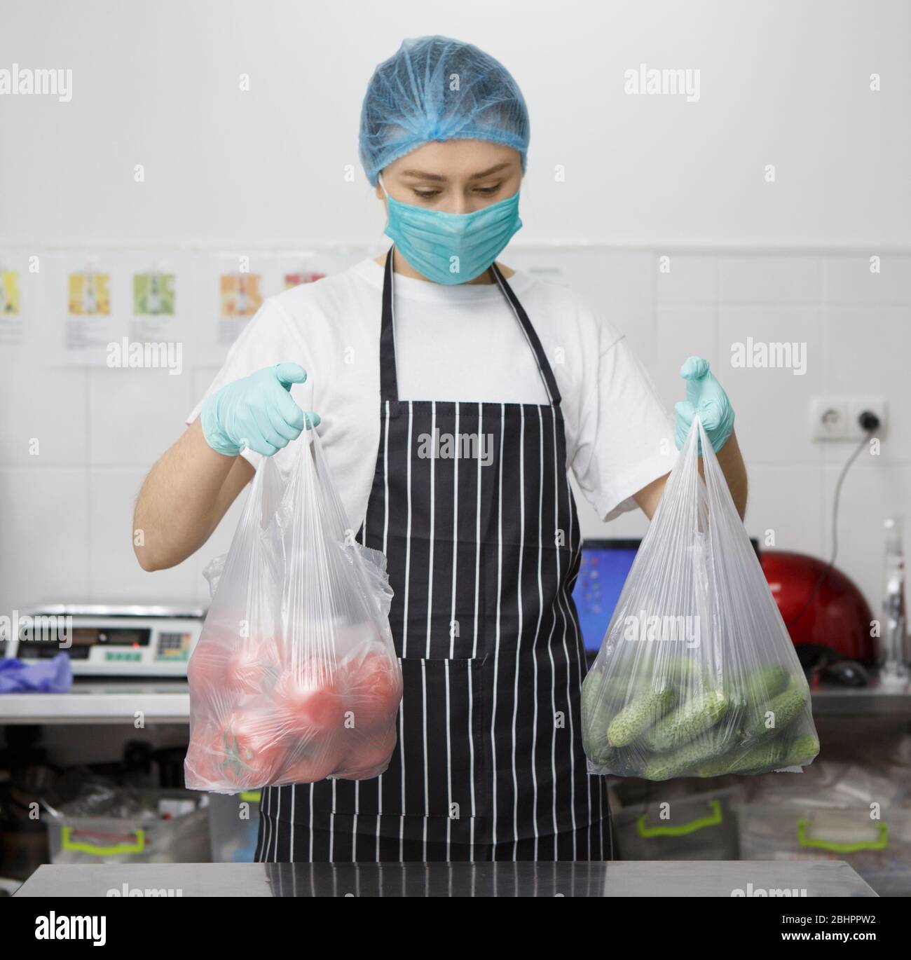 Woman in mask and gloves holding bags with fresh vegetables Stock Photo ...