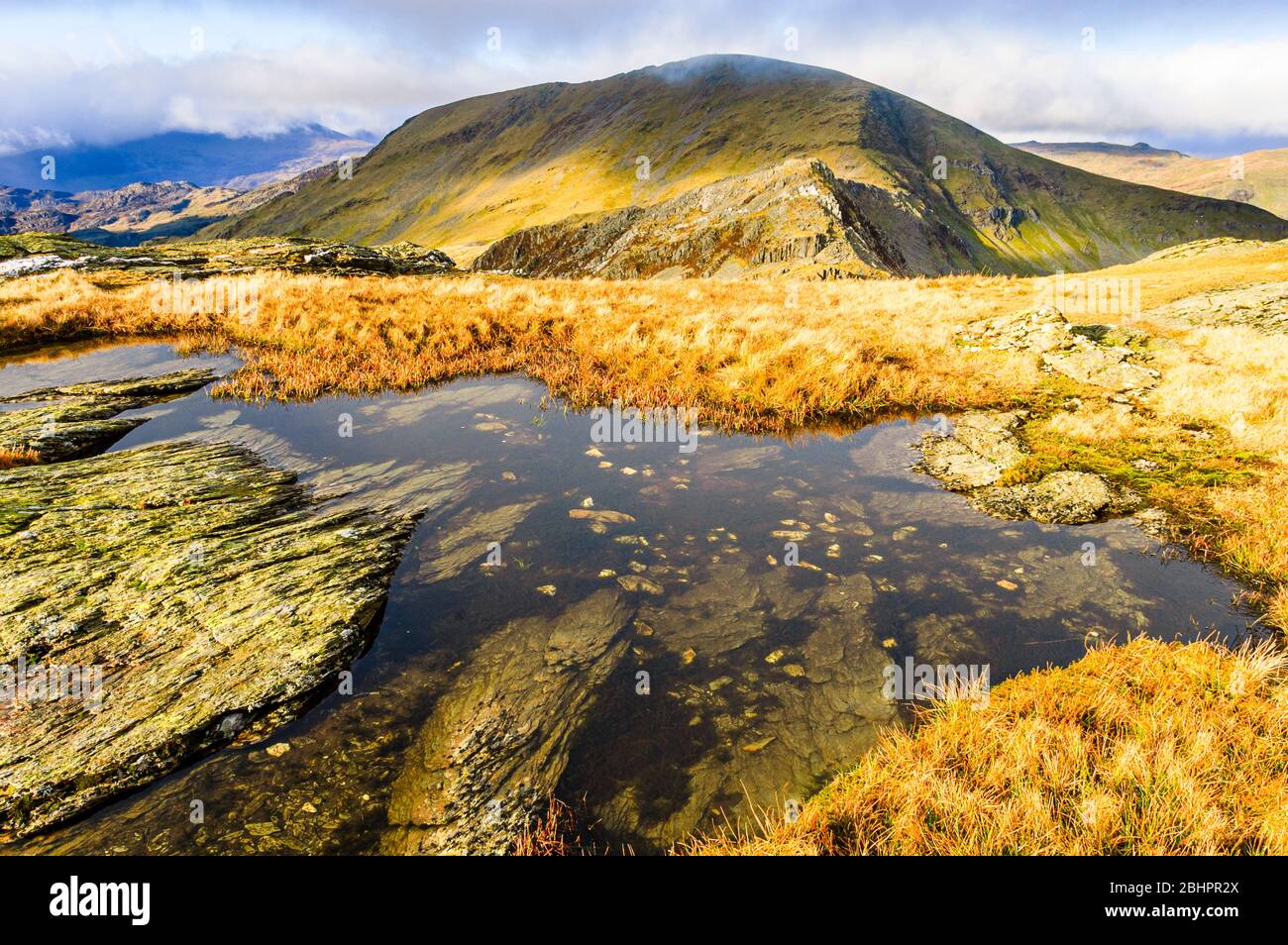 Pool near summit of Moelwyn Bach, Snowdonia, Wales. Craigysgafn ridge leading to Moelwyn Mawr behind. Stock Photo