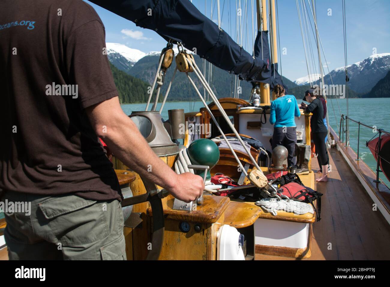 The crew and passengers on an ecotourism schooner in the coastal waters of the Great Bear Rainforest, northern British Columbia, Canada. Stock Photo