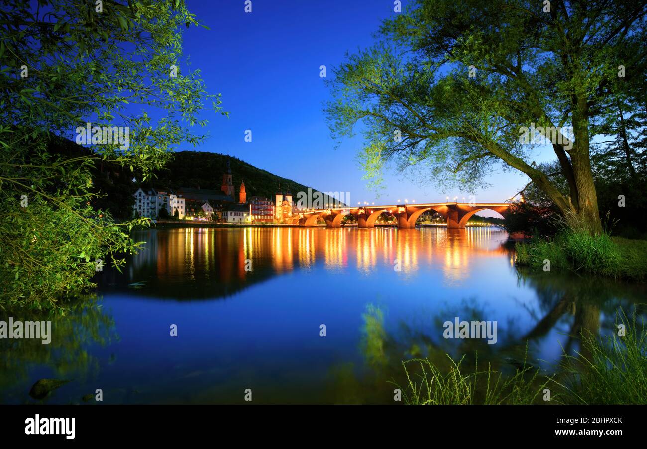 Neckar river in Heidelberg, Germany, at dusk, with deep blue sky