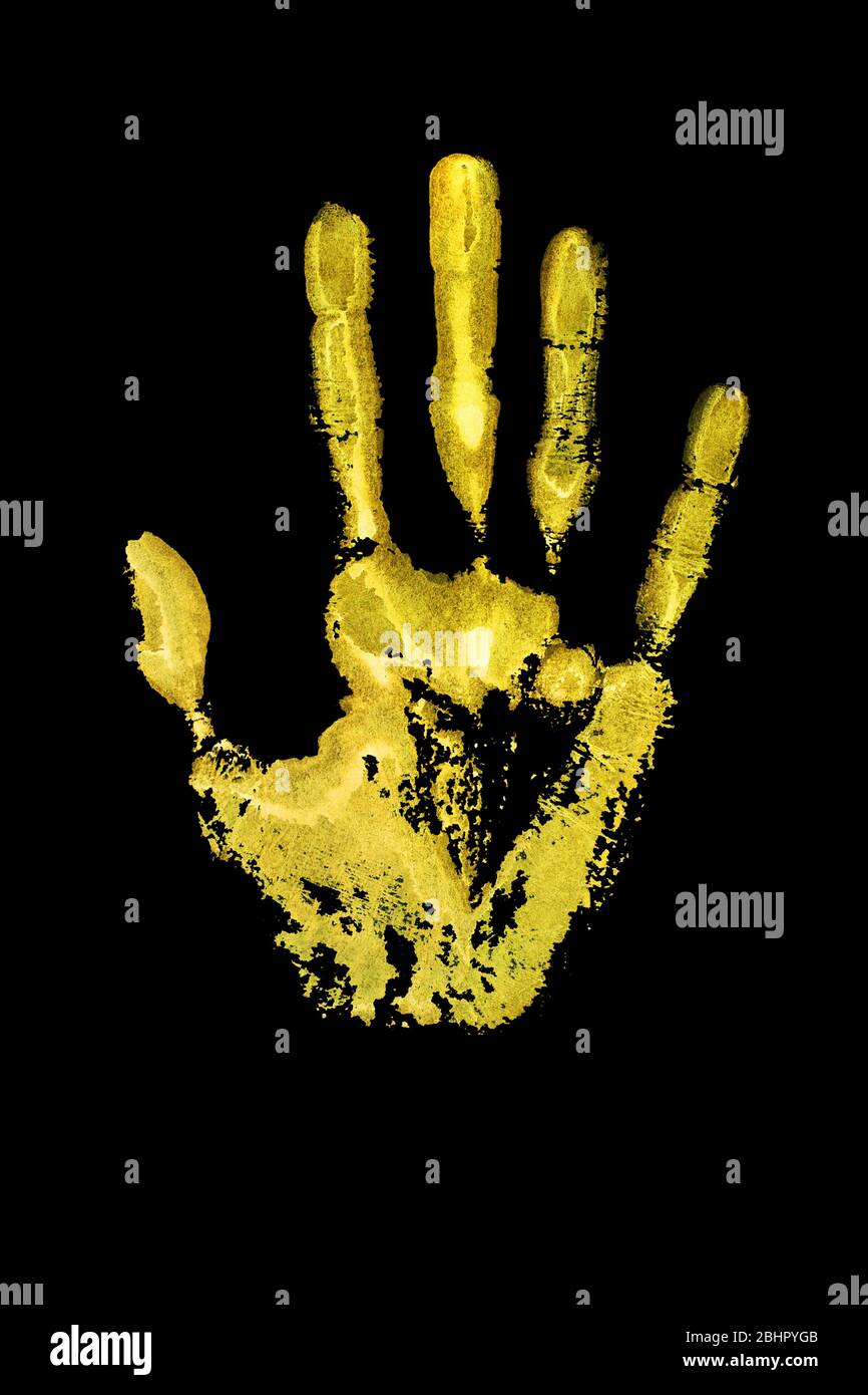 Yellow human hand print on black background isolated close up