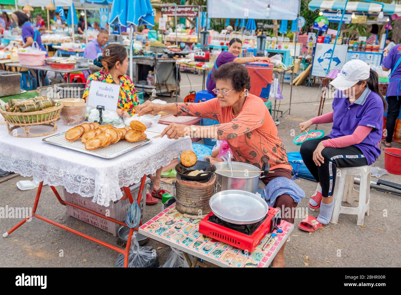 Thai old woman is making the Thai old pudding with her secret recipe which is called Phuck-bua at Pranburi street market Pranburi, Thailand Aprilk 28, Stock Photo