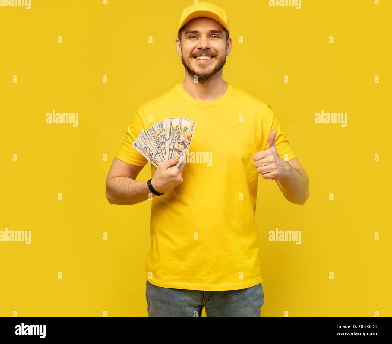 Cheerful excited ecstatic overjoyed man throwing money away showing his