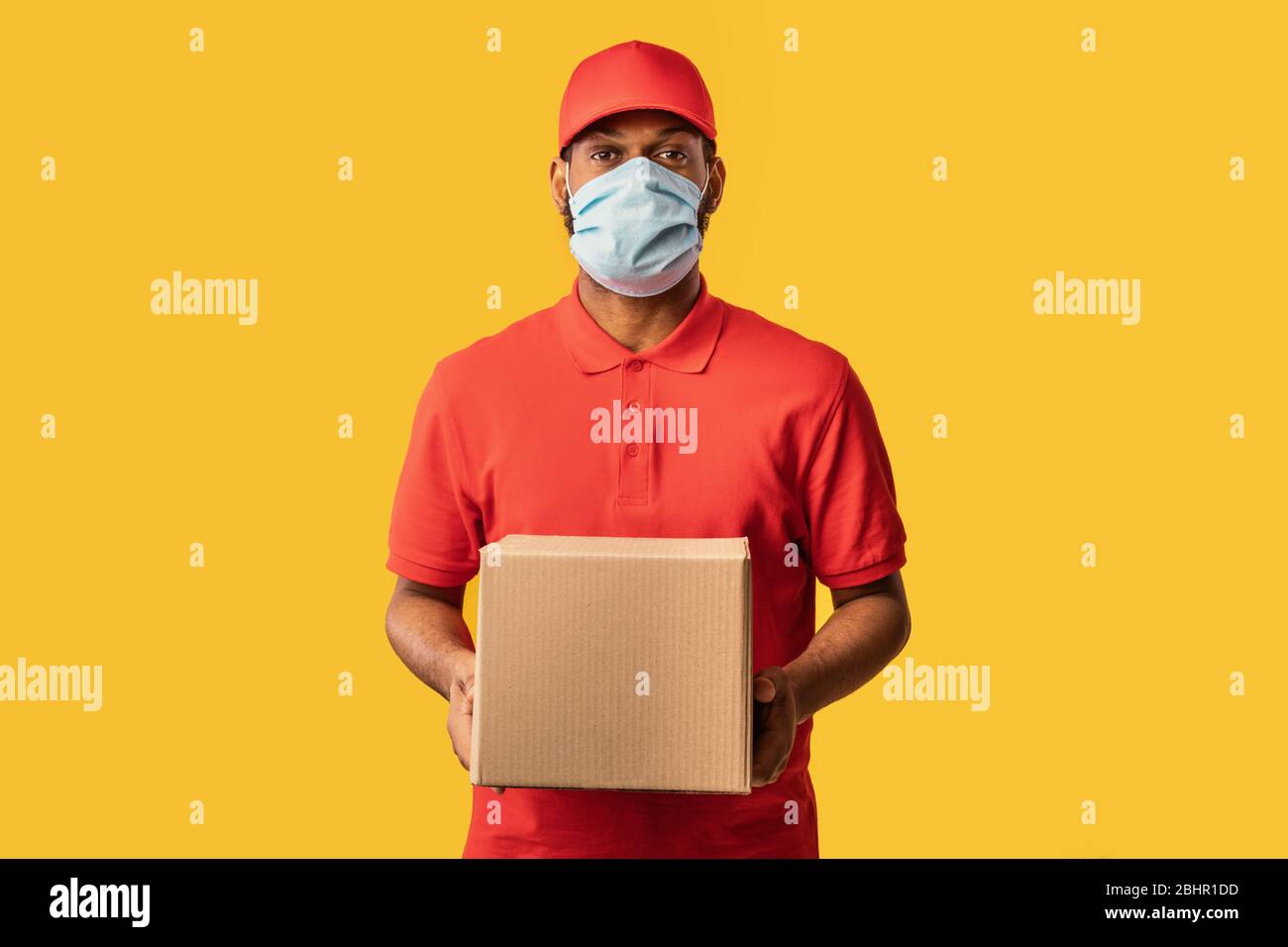 Black Courier Guy Delivering Cardboard Box Wearing Mask, Yellow
