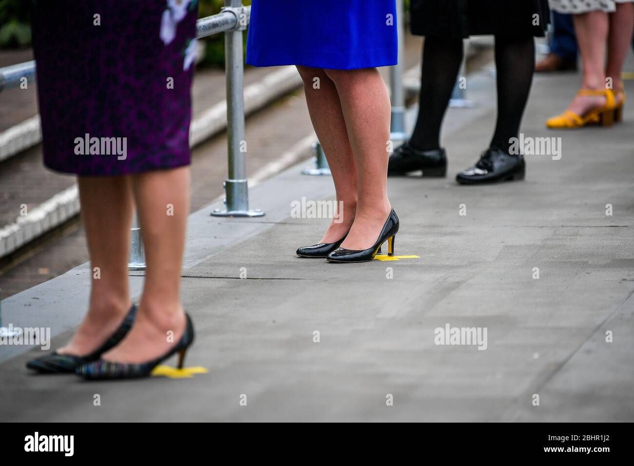 EMBARGOED TO 1700 MONDAY APRIL 27 NHS staff stand on yellow crosses taped to the floor to indicate a safe social distance during the formal opening of Bristol Nightingale Hospital, which is located at the University of the West of England. Stock Photo