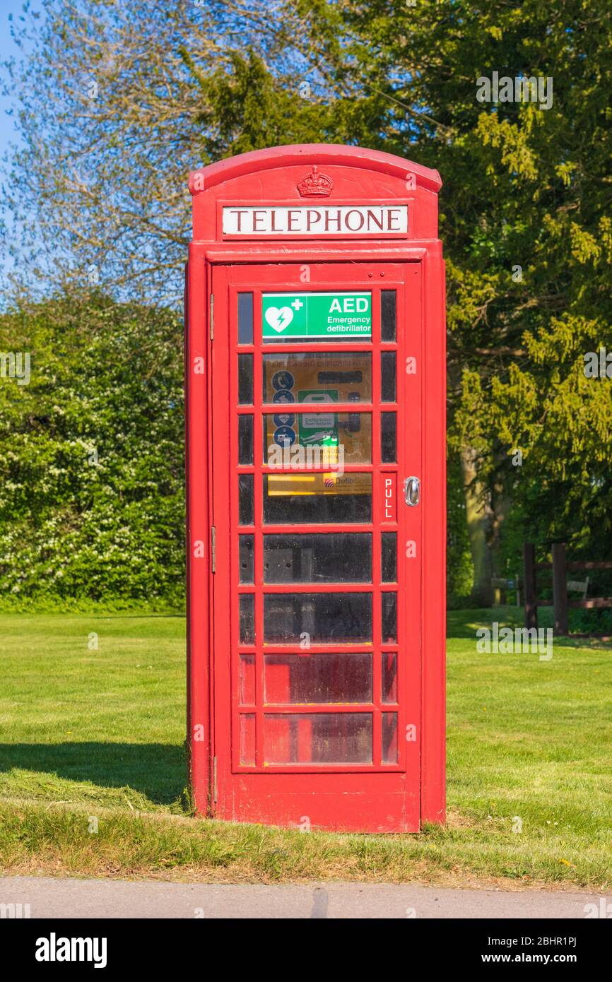 Life saving defibrillator located in an old telephone box in Perry Green, Much Hadham, Hertfordshire. UK Stock Photo