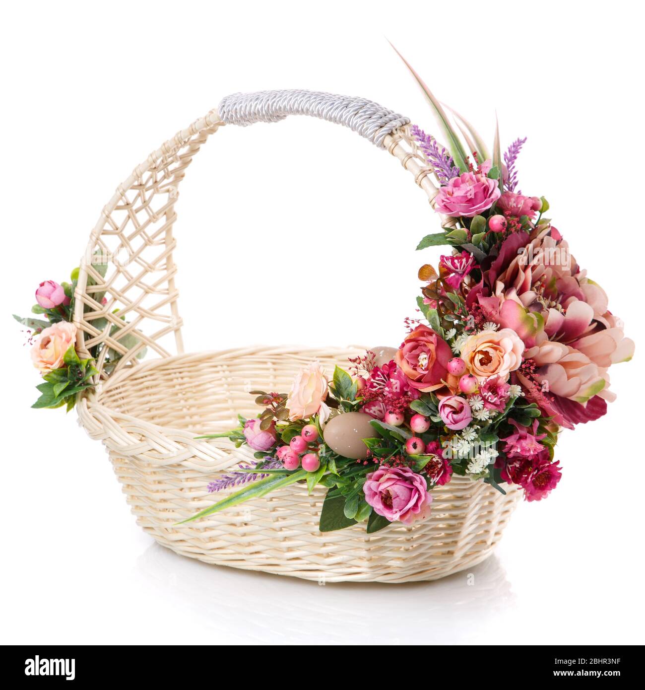 Wicker basket decorated with flowers on white background Stock Photo ...