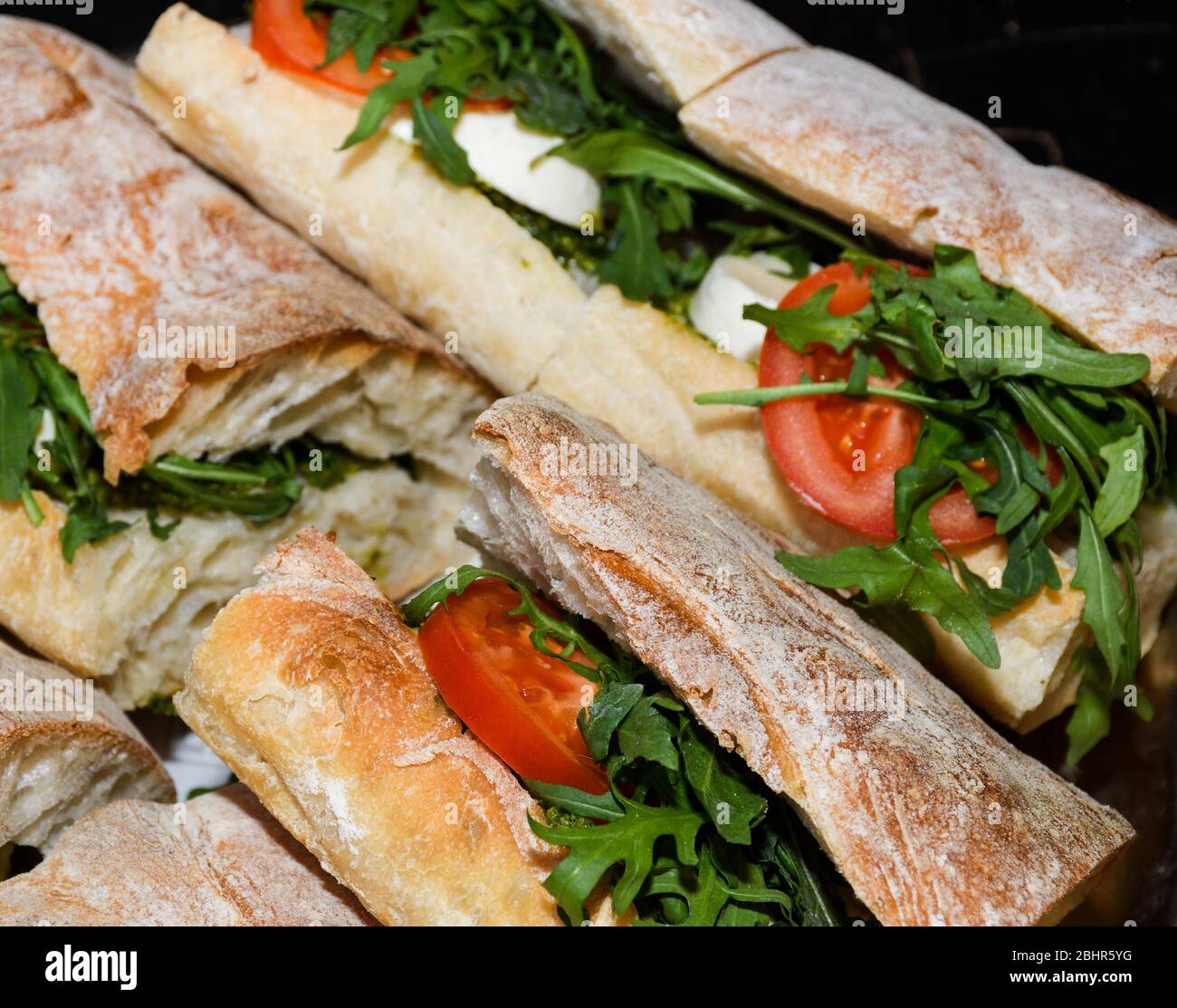 Sandwiches display during fast food festival outdoor event. Outside catering. Food Buffet Catering Dining Eating Party Sharing Concept. Meat, bacon, c Stock Photo