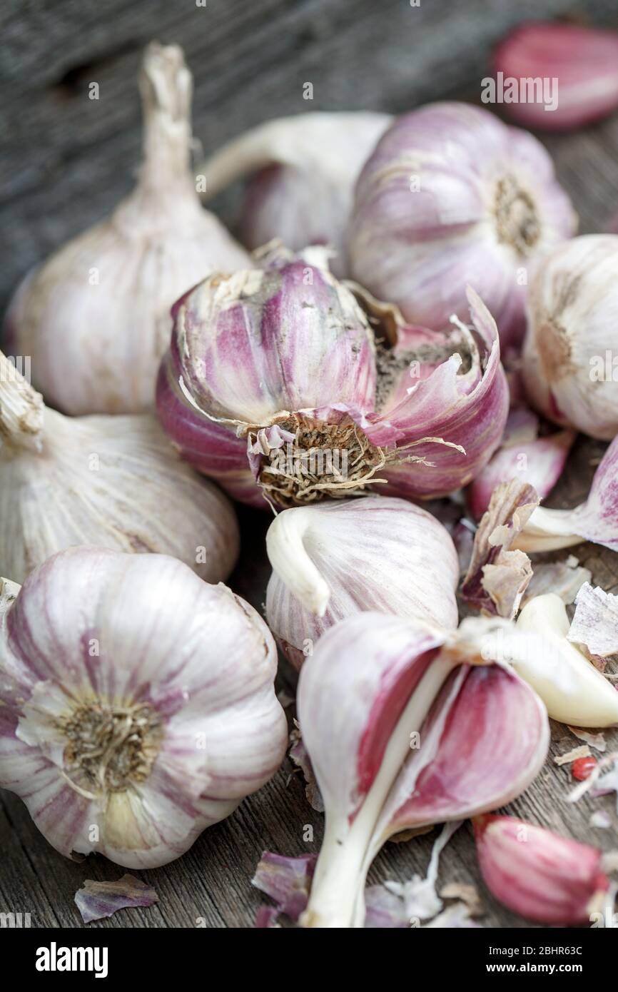 Peeled garlic on a vintage gray wooden background Stock Photo - Alamy