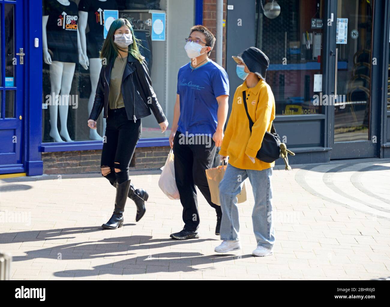Group of 3 students, in masks, walking, during Corona virus lockdown Stock Photo