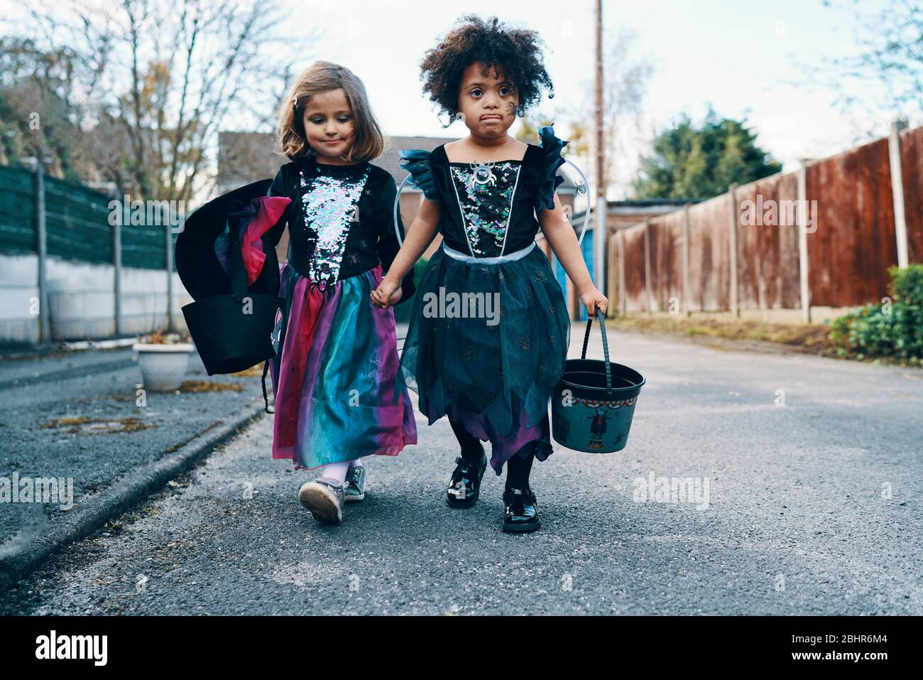 Two girls walking down road hi-res stock photography and images - Alamy