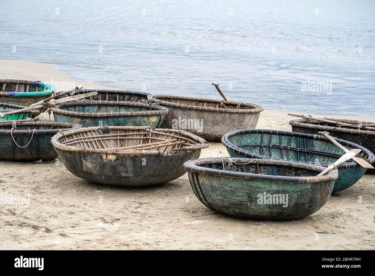 Close up, traditional Vietnamese boat placed on a tropical beach located in My Khe Beach, Danang, Vietnam. This round basket boat is made of woven bam Stock Photo